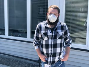 Lionel Booth a Residential Team Leader at Crisis & Counseling Centers is pictured wearing a KN95 mask in front of C&C’s Caldwell Road offices in Augusta.